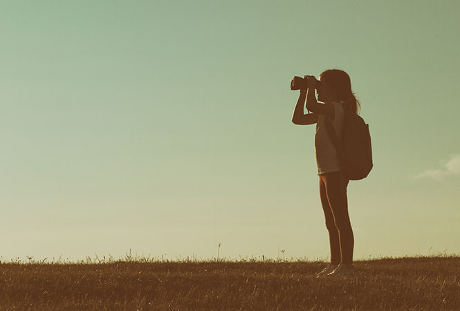 Little girl looking through binoculars