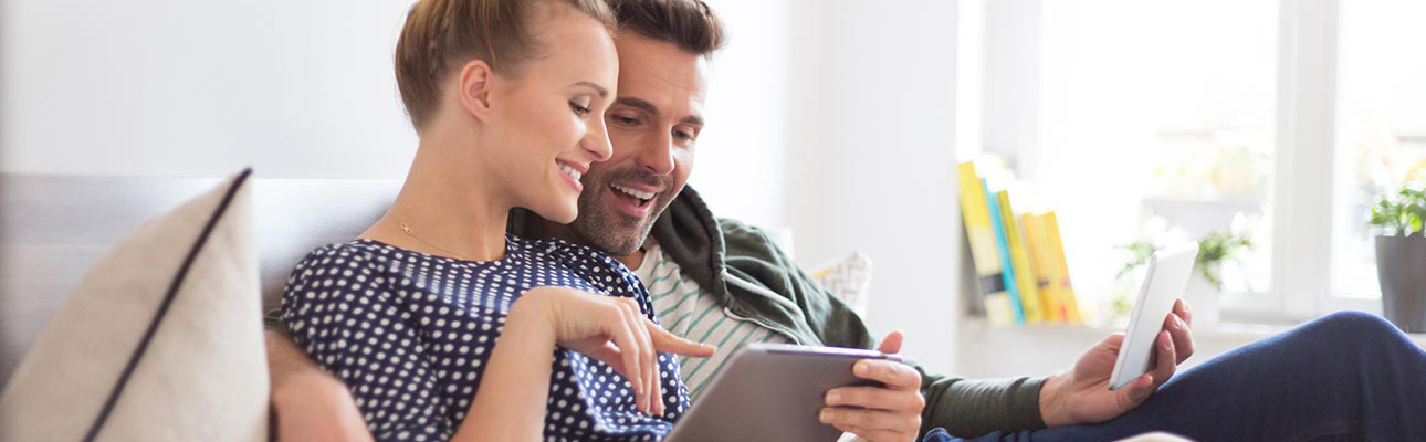 Man and woman looking together at tablet